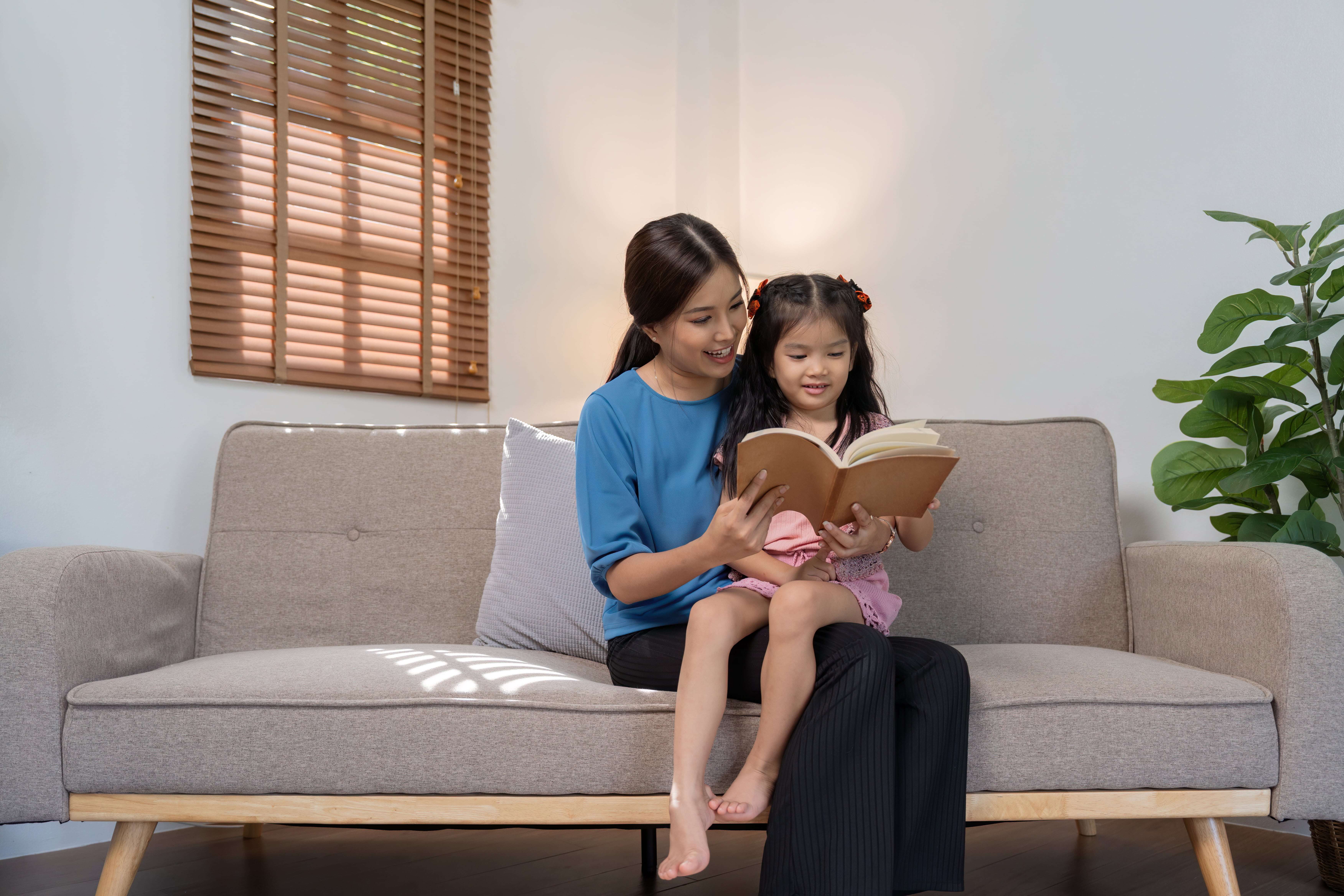 Parent reading with child to develop language skills for Primary 1.